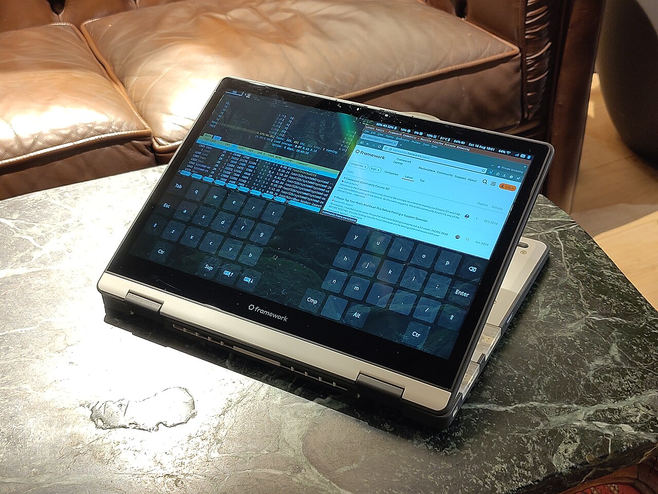ภาพประกอบ: Framework Laptop 12 running Sway, Firefox, wvkbd, and htop